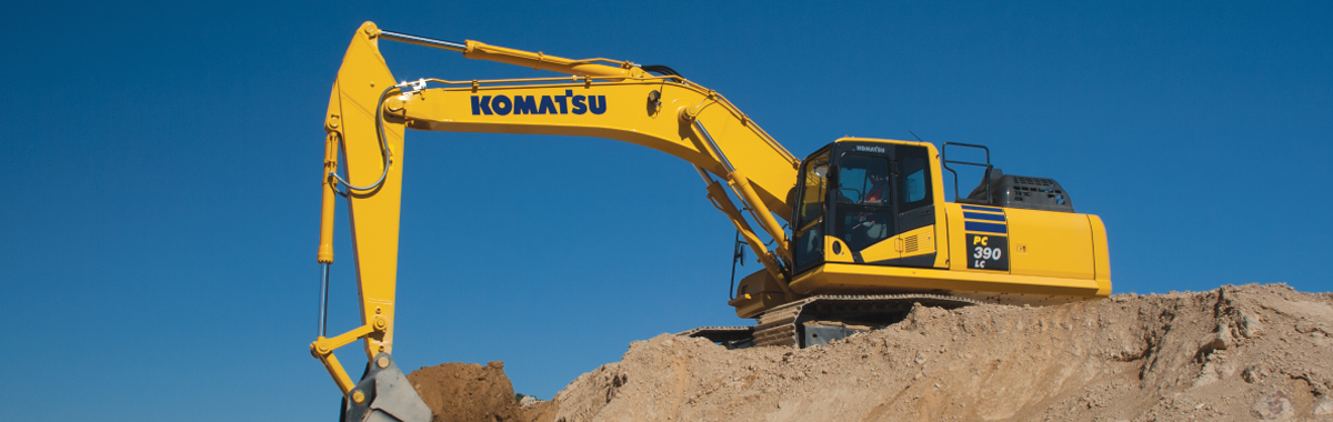 Komatsu excavator on pile of dirt