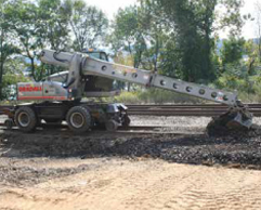Gradall excavator on rail wheels digging dirt