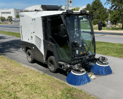 Madvac sweeper cleaning sidewalk
